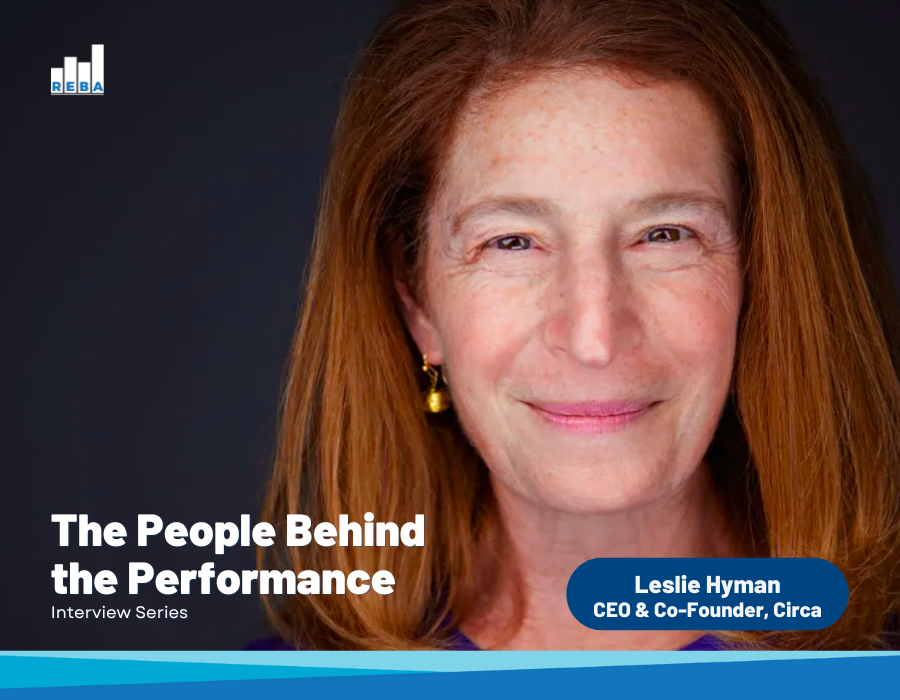 A woman with long auburn hair smiles at the camera. Text reads: The People Behind the Performance, Interview Series and Leslie Hyman, CEO & Co-Founder, Circa. REBA logo appears at the top left.