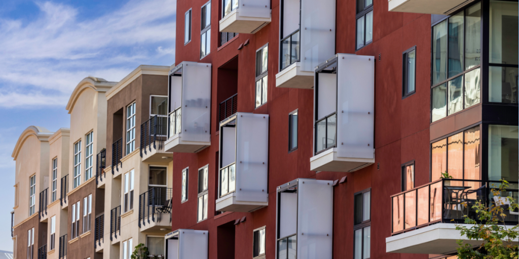 Modern multifamily apartment building with contemporary balconies and large windows,