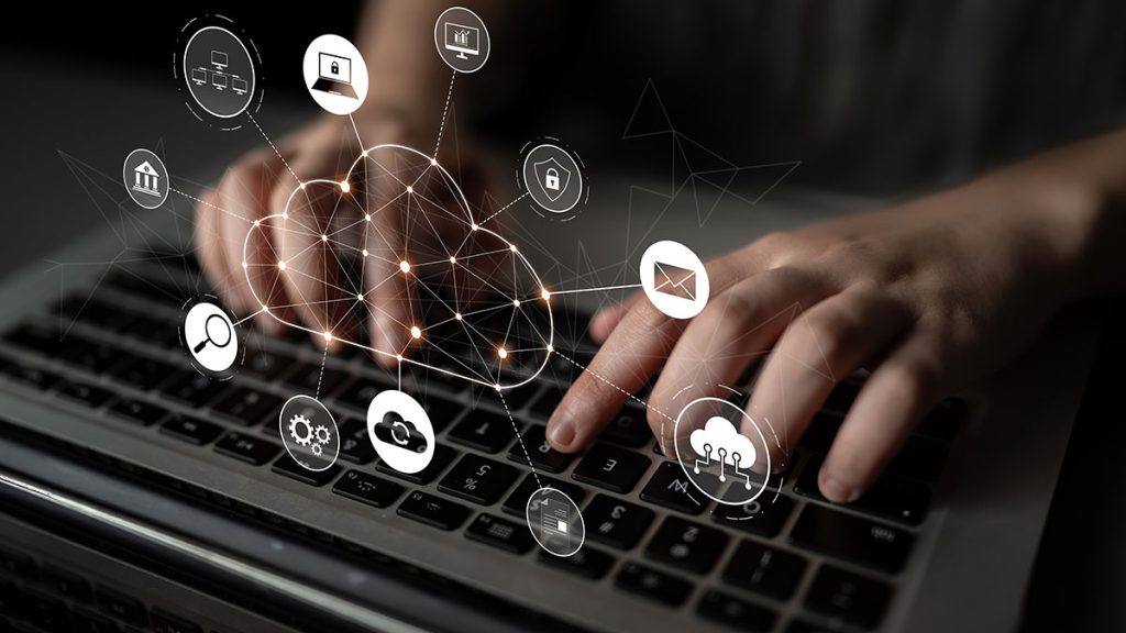 Hands typing on a laptop keyboard with digital icons and lines representing integrations, cloud computing, data sharing, email, security, and internet connectivity overlaid on the image.